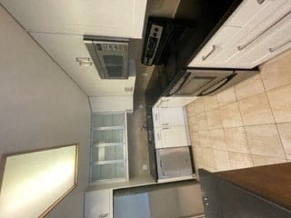 a kitchen with a stove top oven and a sink